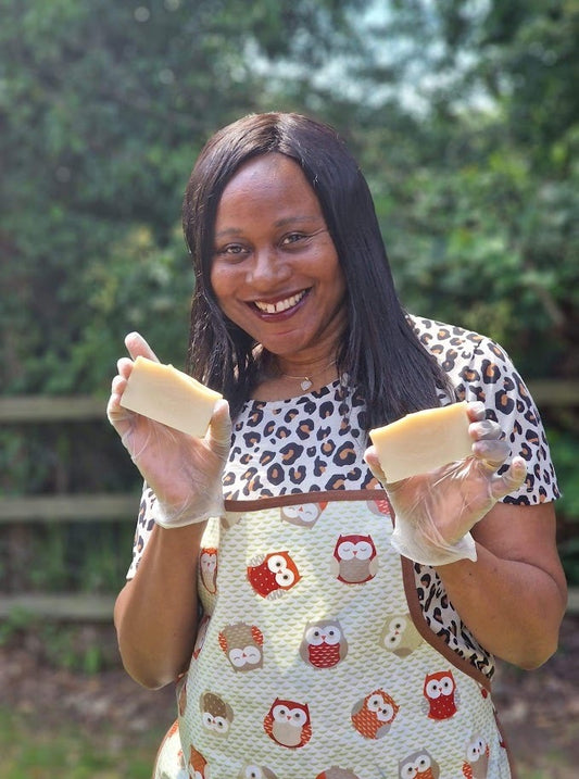 Mel holding a bar of coconut and pineapple soap in each hand